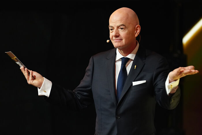 FIFA President Gianni Infantino in a dark suit speaking at an event amid ethics complaint over peace prize controversy. FIFA President Gianni Infantino in a dark suit speaking at an event amid ethics complaint over peace prize controversy.