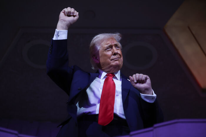 Donald Trump raising fist at an event, linked to FIFA ethics complaint over Infantino peace prize decision. Donald Trump raising fist at an event, linked to FIFA ethics complaint over Infantino peace prize decision.