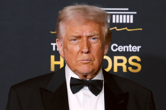 Former President Trump in a tuxedo at a formal event, related to musician canceling Kennedy Center show over rename controversy.