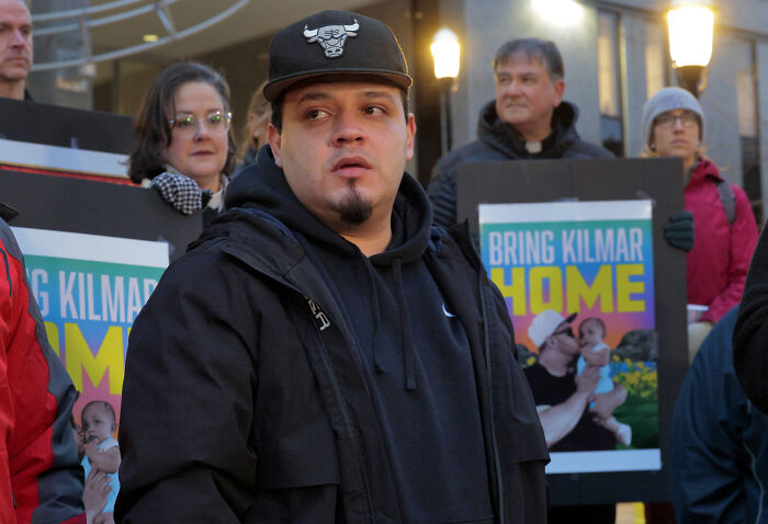 Kilmar Abrego Garcia at a public event pledging to fight Trump administration, surrounded by supporters holding signs. Kilmar Abrego Garcia at a public event pledging to fight Trump administration, surrounded by supporters holding signs.