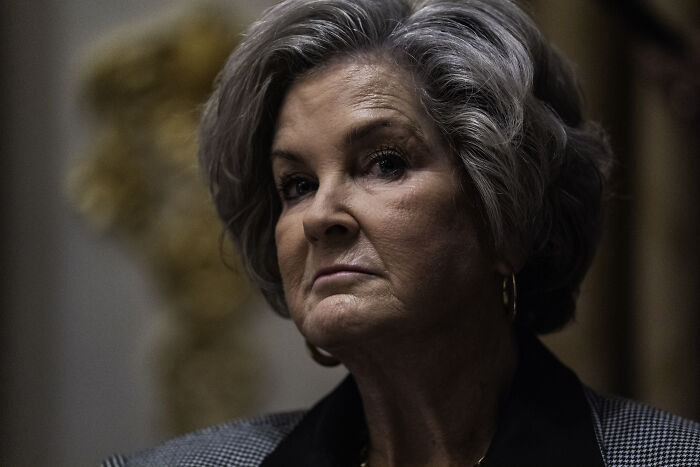 Woman with gray hair and serious expression, representing Trump’s chief of staff in a formal indoor setting. Woman with gray hair and serious expression, representing Trump’s chief of staff in a formal indoor setting.
