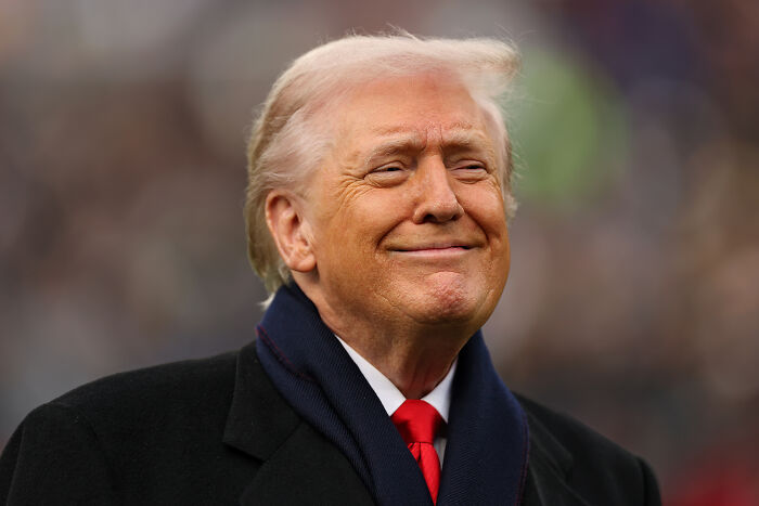 Donald Trump in a suit outdoors, smiling with a confident expression, related to Trump’s chief of staff backpedaling news. Donald Trump in a suit outdoors, smiling with a confident expression, related to Trump’s chief of staff backpedaling news.