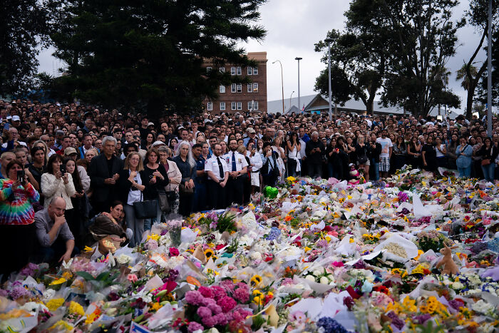 Large crowd gathered at a public memorial laying flowers reflecting on Australia's gun laws after first mass shooting in 30 years. Large crowd gathered at a public memorial laying flowers reflecting on Australia's gun laws after first mass shooting in 30 years.