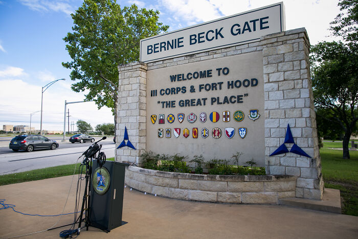 Entrance sign for Fort Hood with a podium of microphones, related to army gynecologist accused of secretly recording patients during exams Entrance sign for Fort Hood with a podium of microphones, related to army gynecologist accused of secretly recording patients during exams