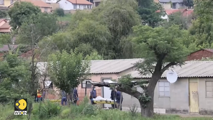 Emergency responders carrying victims on stretchers near a rural house after a fatal mass shooting involving children and teens. Emergency responders carrying victims on stretchers near a rural house after a fatal mass shooting involving children and teens.