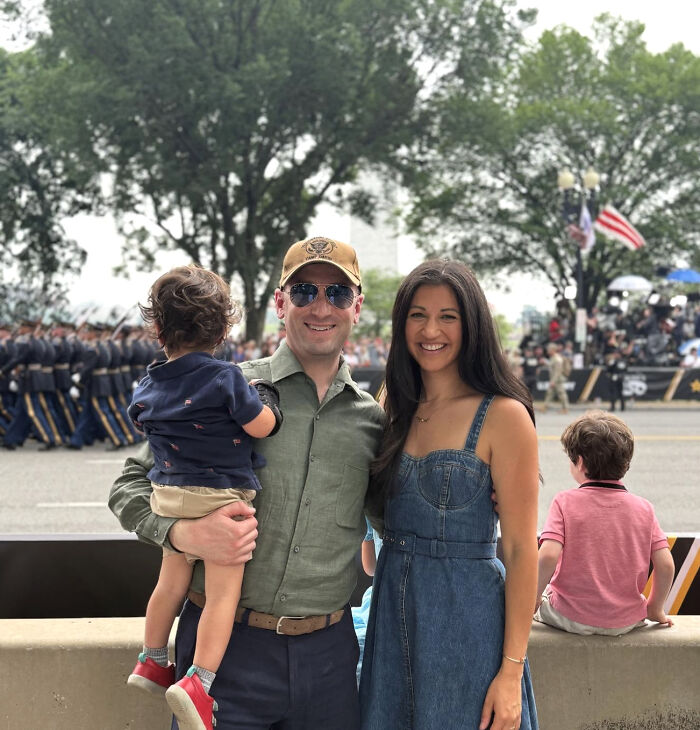 Stephen Miller’s wife smiling outdoors with family, enjoying a public event after leaving her husband's team. Stephen Miller’s wife smiling outdoors with family, enjoying a public event after leaving her husband's team.