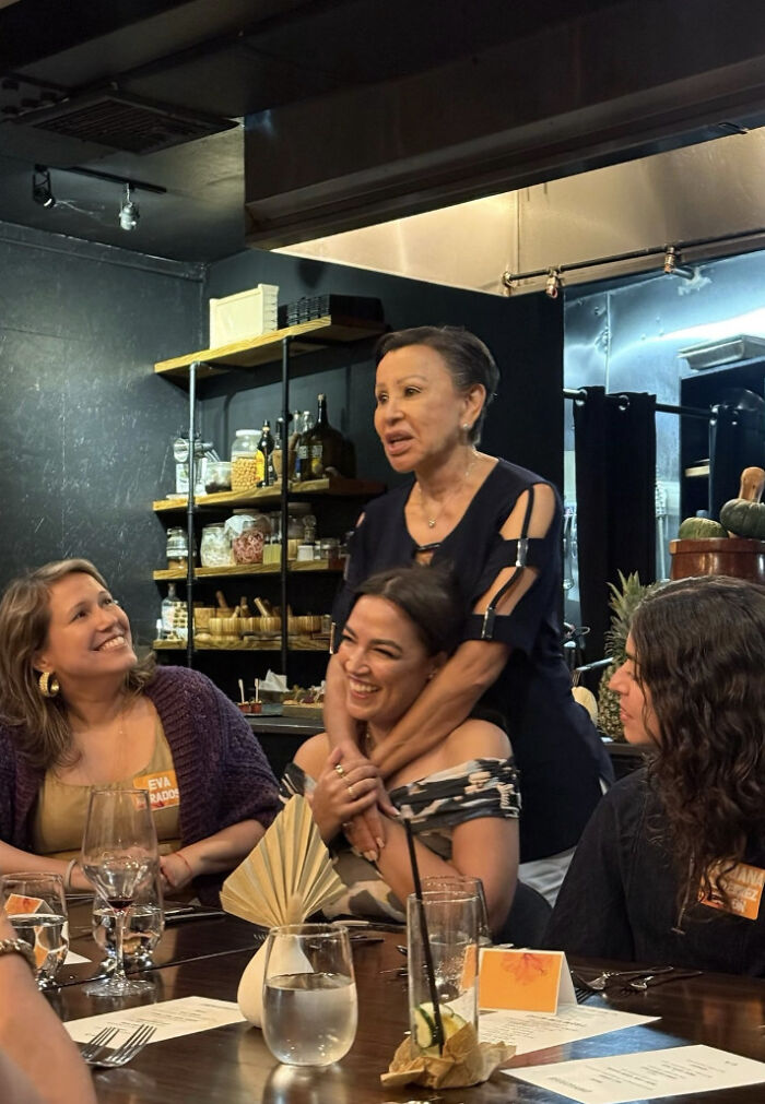 Women enjoying fine dining experience at a restaurant, highlighting luxury hotels and Puerto Rico venue spending by AOC. Women enjoying fine dining experience at a restaurant, highlighting luxury hotels and Puerto Rico venue spending by AOC.