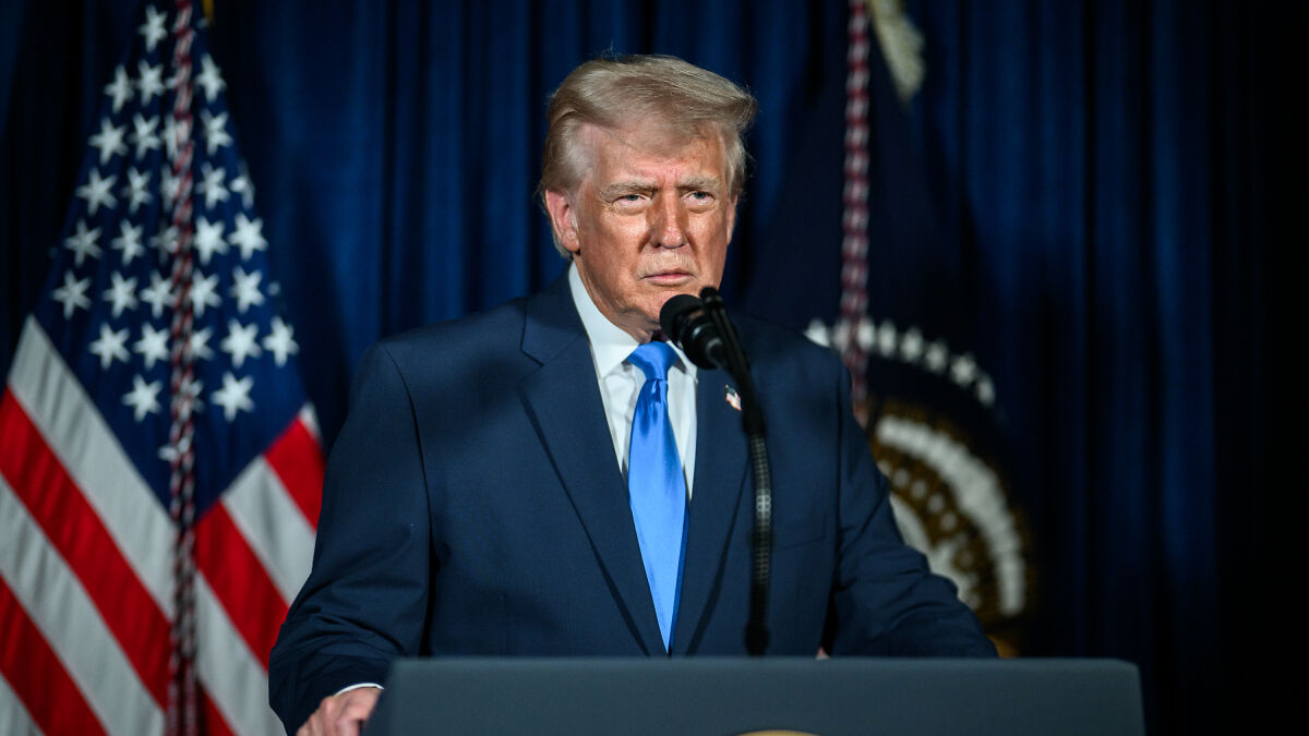 Donald Trump speaking at a podium during a tirade of insults against female reporters about MRI results.