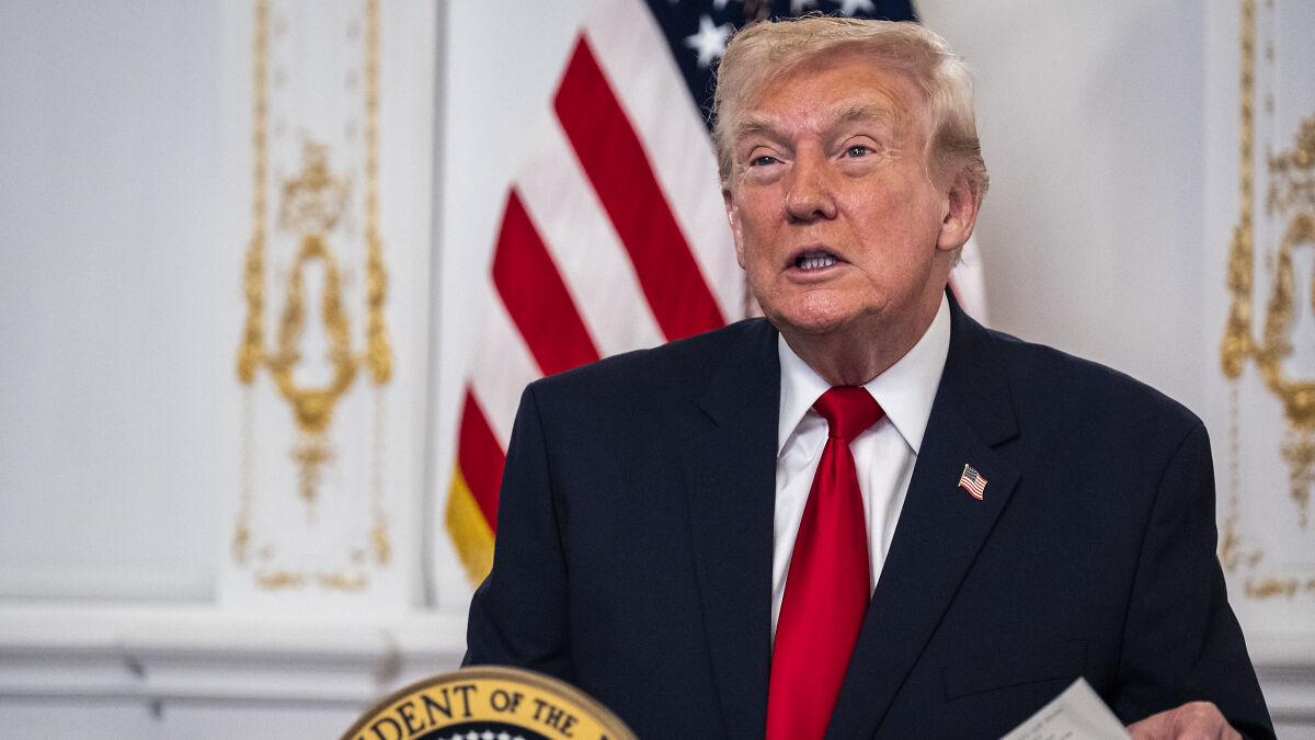 Donald Trump speaking at a podium with an American flag, related to GPB Capital founder defrauding scheme case.
