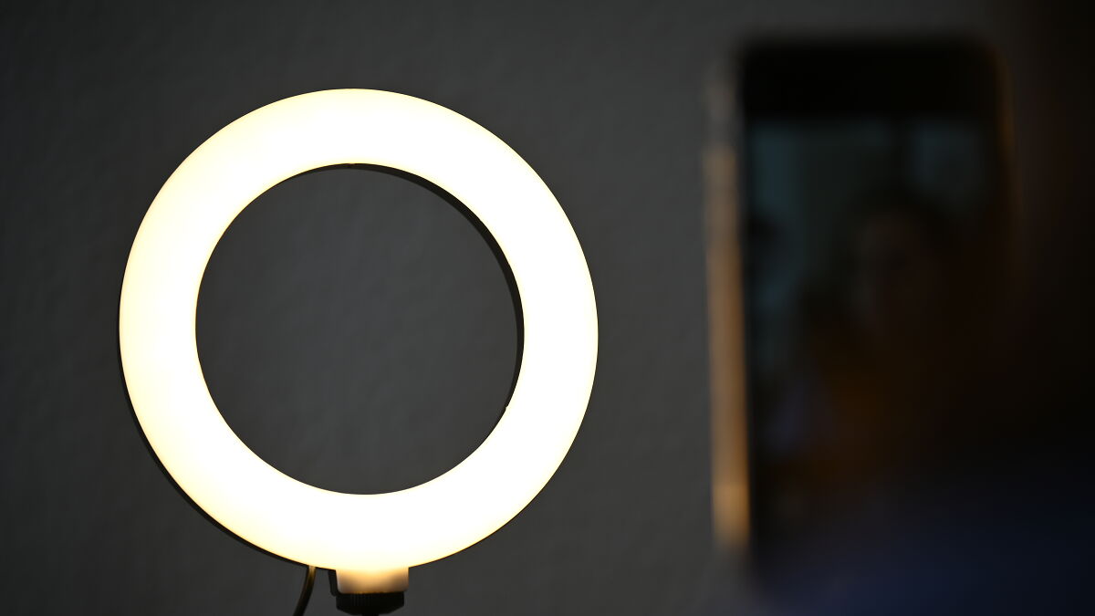 IRS agents reviewing digital content under bright ring light for no tax on tips claims investigation