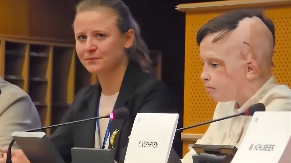 Interpreter holding back tears during Ukrainian boyu2019s emotional testimony at European Parliament session.