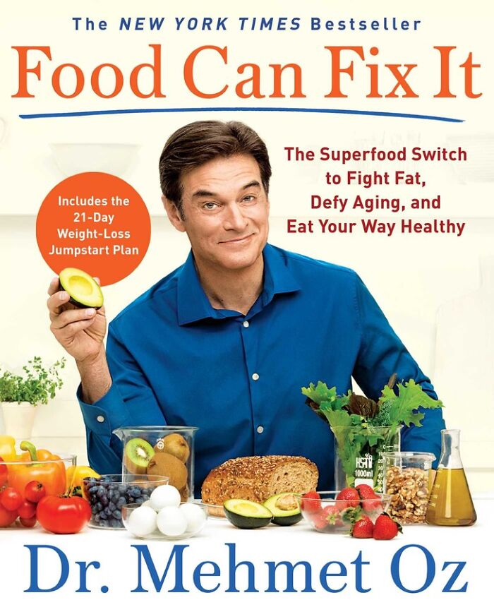 Dr. Oz in a blue shirt holding avocado, surrounded by healthy foods promoting weight loss and eating less during holidays. Dr. Oz in a blue shirt holding avocado, surrounded by healthy foods promoting weight loss and eating less during holidays.