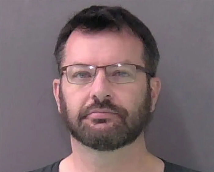 Mugshot of a man wearing glasses with a beard, related to the army gynecologist accused of secretly recording patients. Mugshot of a man wearing glasses with a beard, related to the army gynecologist accused of secretly recording patients.