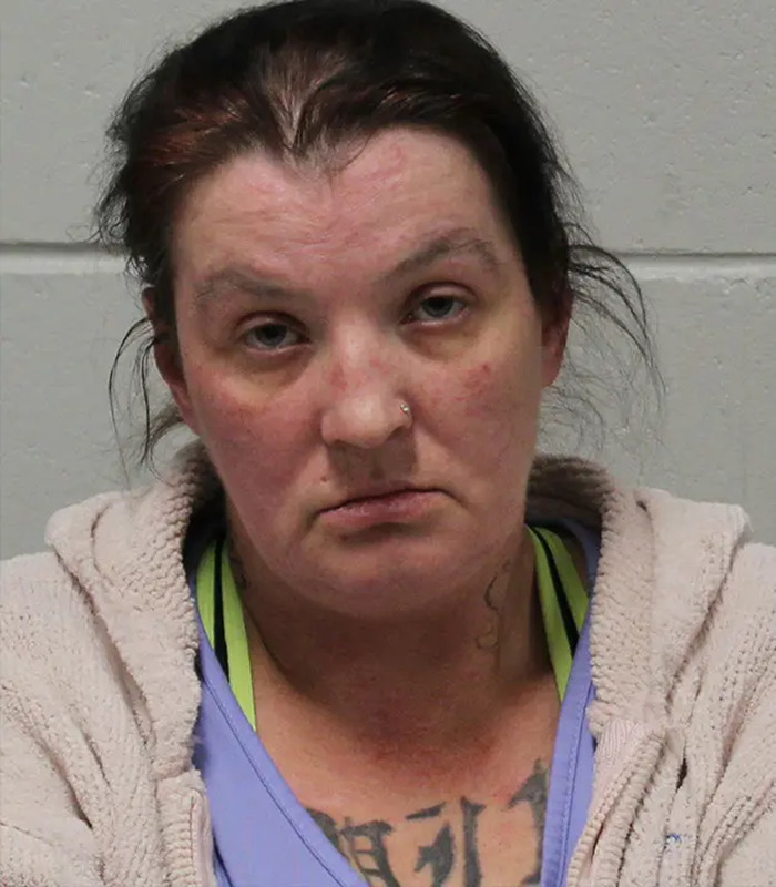 Woman accused in case involving slain daughter and unborn child, shown in a mugshot with neutral expression against plain background