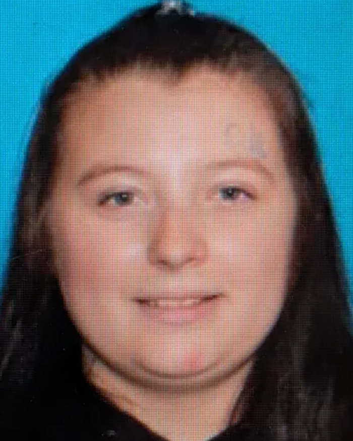 Young woman with long dark hair and blue eyes, related to parents accused in case of slain daughter and unborn child separation.