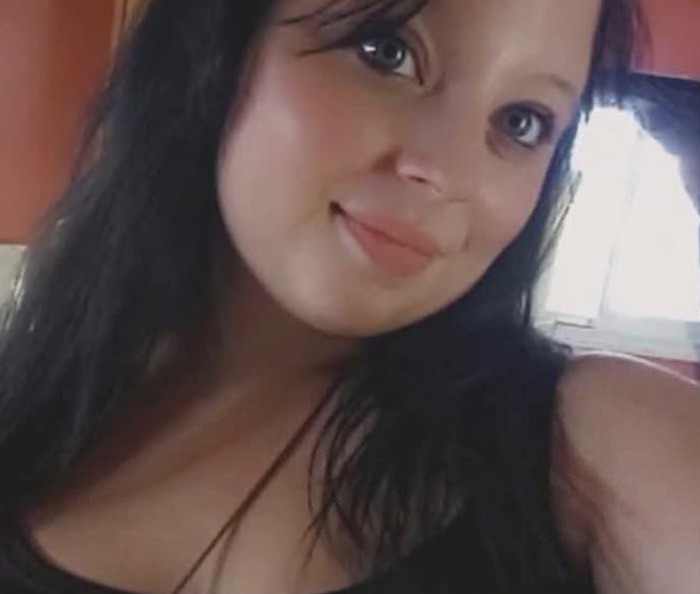 Young woman with long dark hair smiling softly in a home setting related to parents accused in forcible separation case