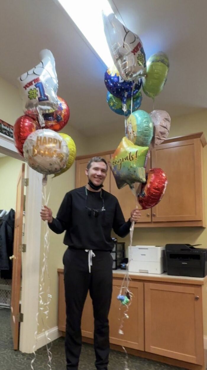 Smiling man holding colorful celebration balloons in an office, Slain Ohio Couple Smiling man holding colorful celebration balloons in an office, Slain Ohio Couple