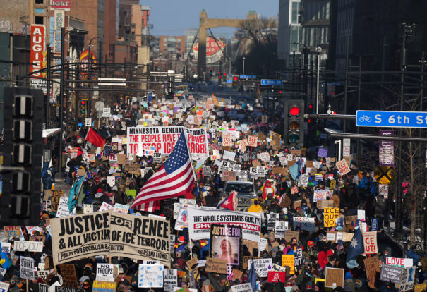 Crowd of protesters holding an anti-ICE protest sign amid a large demonstration sparking vital debate on immigration policies
