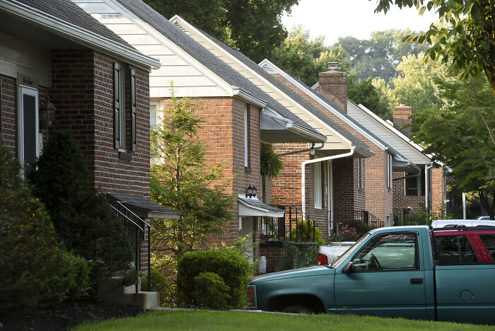 Row of single-family homes with parked cars in a suburban neighborhood, reflecting impact of Blackstone shares plummet news.