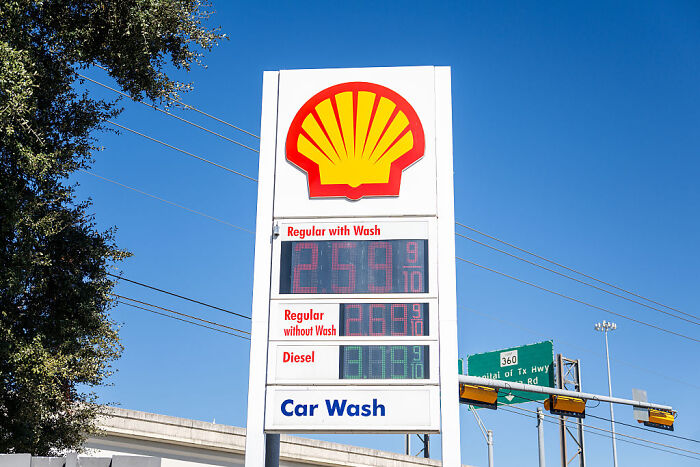 Shell gas station price sign showing gas prices with blue sky, related to Trump fact-checked on gas prices topic. Shell gas station price sign showing gas prices with blue sky, related to Trump fact-checked on gas prices topic.