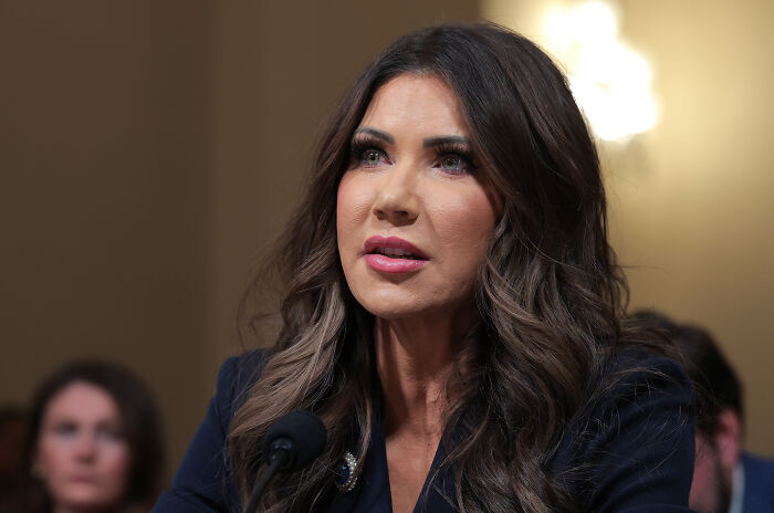 Kristi Noem speaking at a hearing, responding to questions about ICE officer and Renee Good controversy.