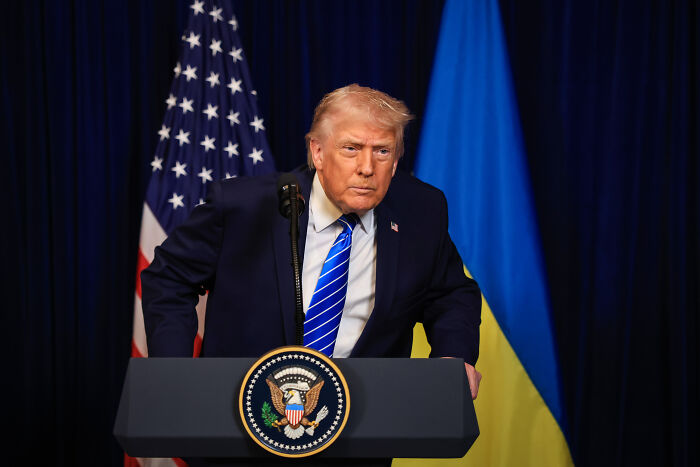 Former President Trump at a podium with American and Ukrainian flags, related to health issues and compression socks. Former President Trump at a podium with American and Ukrainian flags, related to health issues and compression socks.