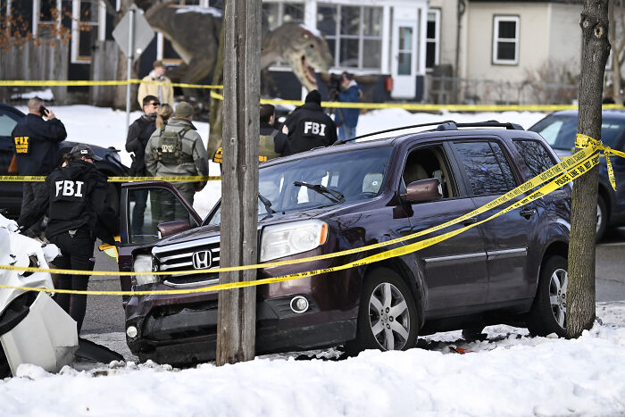 FBI agents investigate a crime scene involving a SUV and police tape after fatal shooting linked to ICE incident. FBI agents investigate a crime scene involving a SUV and police tape after fatal shooting linked to ICE incident.