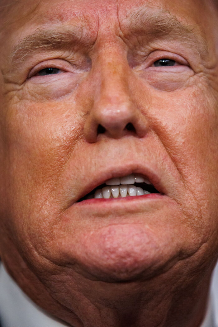 Close-up of Trump speaking, highlighting expression during discussion about ICE officer immunity and verbal response.