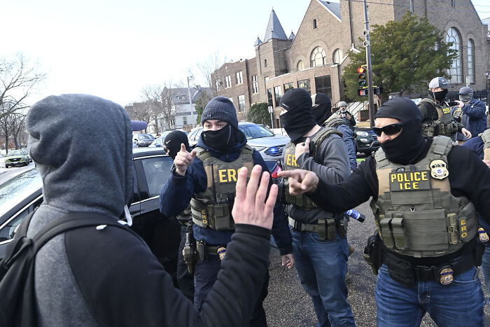 Protesters confront ICE police officers outside a Minnesota church during a demonstration against an ICE pastor.