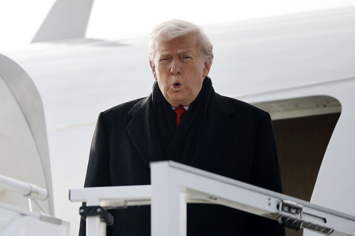 Donald Trump looking embarrassed while exiting plane during a snubbed greeting and woman’s perfect reaction. Donald Trump looking embarrassed while exiting plane during a snubbed greeting and woman’s perfect reaction.
