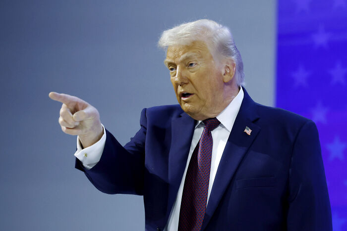 Former President Donald Trump in a dark suit pointing during a speech, related to JB Pritzker and Border Patrol news. Former President Donald Trump in a dark suit pointing during a speech, related to JB Pritzker and Border Patrol news.
