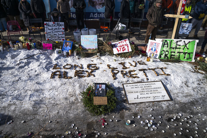 Memorial for Alex Pretti on snow with signs and candles as NRA and Americans call out MAGA 2nd Amendment hypocrisy. Memorial for Alex Pretti on snow with signs and candles as NRA and Americans call out MAGA 2nd Amendment hypocrisy.