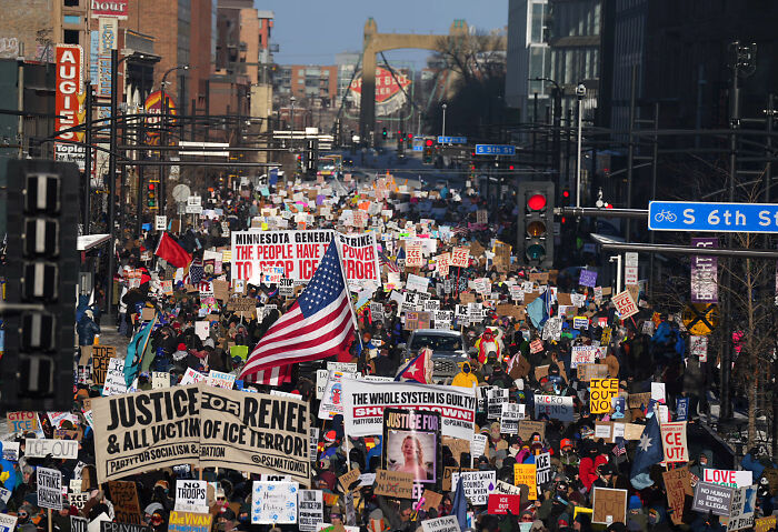 Large protest crowd on city street holding signs about ICE and justice, reflecting Jimmy Kimmel fights back tears after tragedy. Large protest crowd on city street holding signs about ICE and justice, reflecting Jimmy Kimmel fights back tears after tragedy.