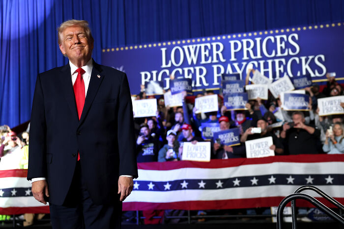 Donald Trump at rally in front of crowd holding signs about lower prices and gas prices fact-checked during speech. Donald Trump at rally in front of crowd holding signs about lower prices and gas prices fact-checked during speech.