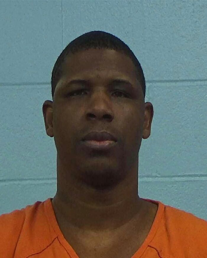 Mugshot of a man in an orange shirt linked to Texas man allegedly crosses state to slay couple case. Mugshot of a man in an orange shirt linked to Texas man allegedly crosses state to slay couple case.