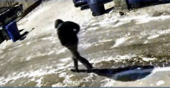 Surveillance image of lone figure walking in snowy driveway near trash bins, related to slain Ohio couple case Surveillance image of lone figure walking in snowy driveway near trash bins, related to slain Ohio couple case