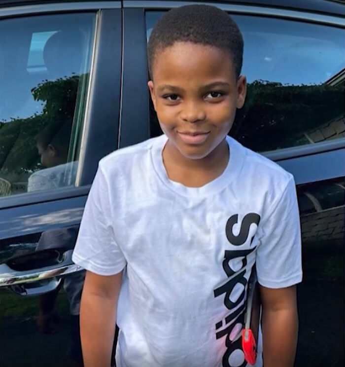 Young boy standing outside near a car, connected to a child a***e case that ended in homicide.