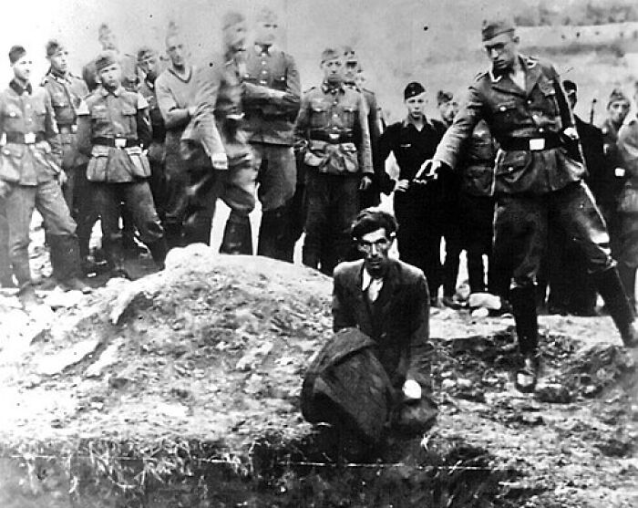 The image appears unrelated to the given title and SEO keywords. It depicts a historical black-and-white scene involving soldiers and a kneeling man, which does not correspond to an anti-ICE protest sign or related debate. Would you like me to create alt text relevant to the actual image content, or based on the provided SEO keywords despite the mismatch?