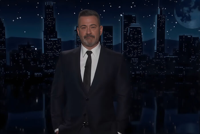 Jimmy Kimmel standing in front of a nighttime cityscape, delivering an emotional speech fighting back tears. Jimmy Kimmel standing in front of a nighttime cityscape, delivering an emotional speech fighting back tears.