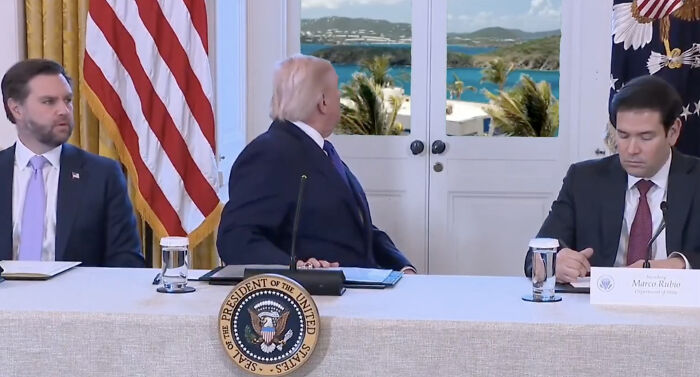 Donald Trump distracted, staring out a window during a meeting, sparking a new wave of memes and online reactions.