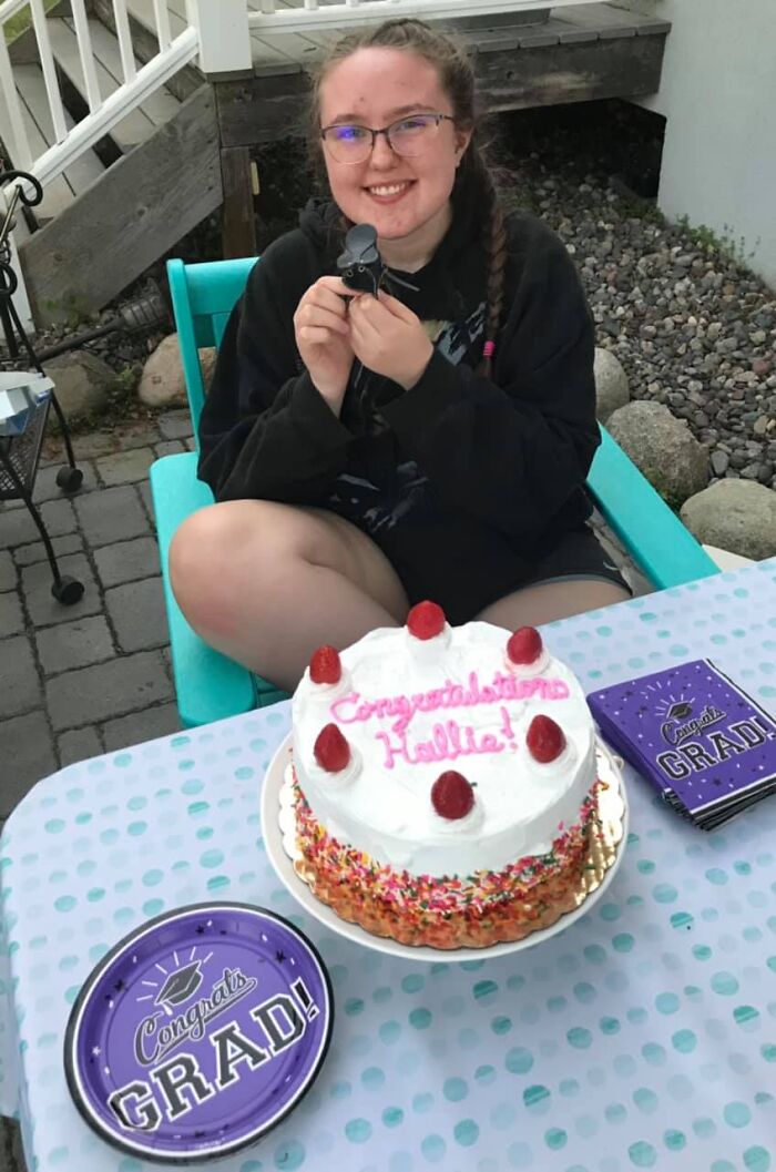 Young woman celebrating graduation with cake and decorations, related to Minnesota gubernatorial candidate's daughter incident.