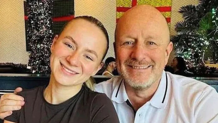 Father and daughter smiling together indoors, illustrating a story about a fatal shooting after a political altercation.