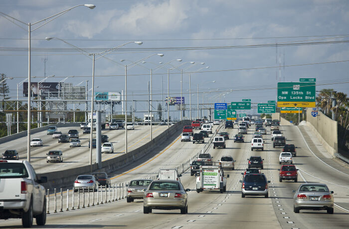 Busy highway in Florida with cars and traffic signs, illustrating people&rsquo;s reaction to Florida&rsquo;s new ridiculous law.