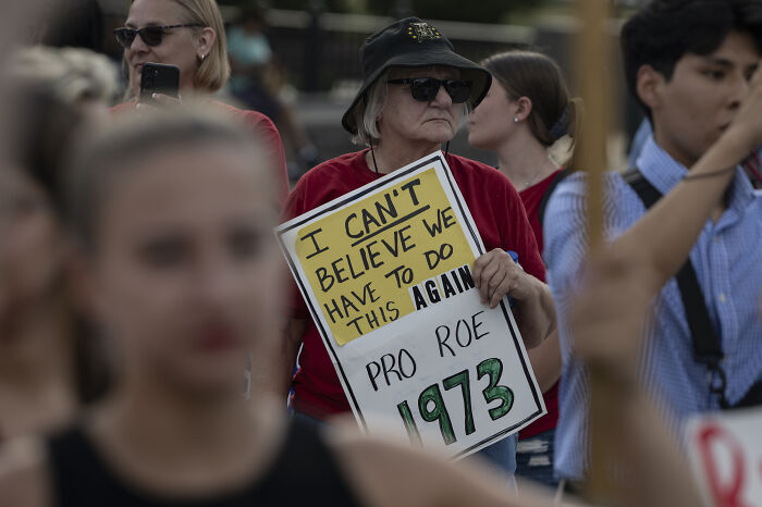 Woman at protest holding a sign about Roe 1973, reflecting views on MAGA ideologies women reveal they cannot handle on dates. Woman at protest holding a sign about Roe 1973, reflecting views on MAGA ideologies women reveal they cannot handle on dates.
