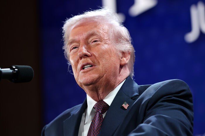 Former president speaking at a podium, representing MAGA ideologies discussed by women on challenging dates. Former president speaking at a podium, representing MAGA ideologies discussed by women on challenging dates.