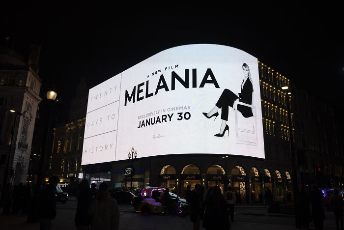 Large illuminated billboard at night promoting the Melania documentary releasing January 30 in cinemas. Large illuminated billboard at night promoting the Melania documentary releasing January 30 in cinemas.