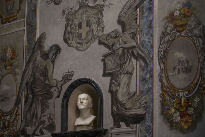 Fresco in a restored church in Rome featuring angels and a sculpted bust with face scrubbed by Pope&rsquo;s diocese orders.