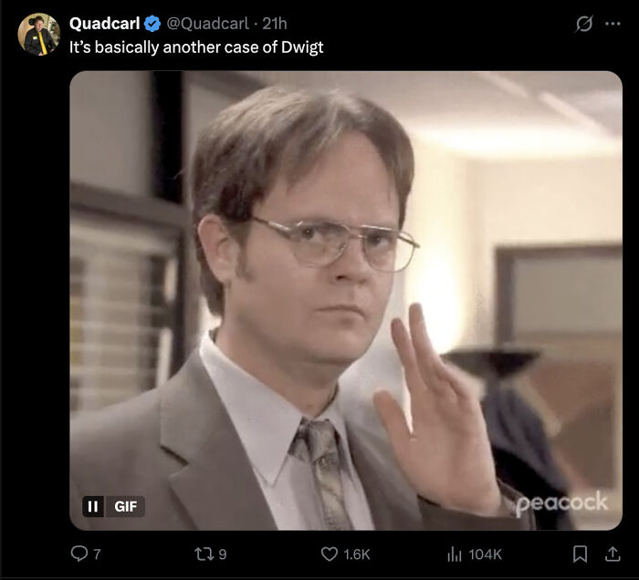 Dwigt Moment GIF of man in glasses and suit raising hand, linked to DOJ redacting Trump's name in Epstein files.