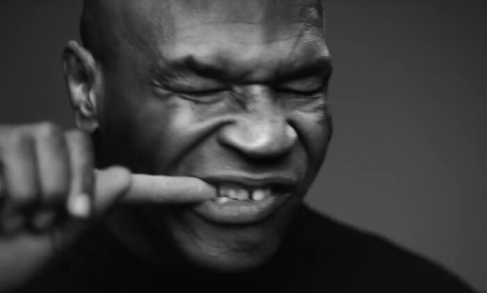 Mike Tyson making a playful face in a close-up black and white shot for Super Bowl MAHA ad campaign.