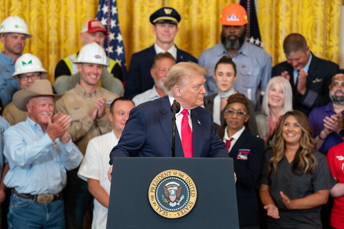 Former President speaking at a podium with crowd behind, related to Minneapolis immigration agents body cameras news.